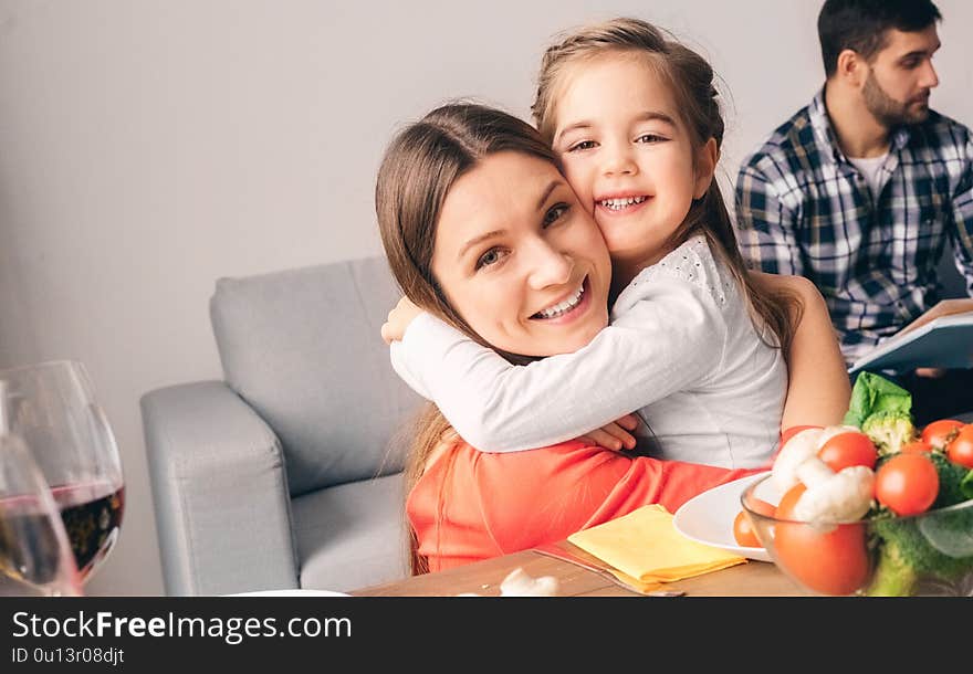 Handsome mother toothy smiling embrace cute little daughter. Love and family concept. Handsome mother toothy smiling embrace cute little daughter. Love and family concept