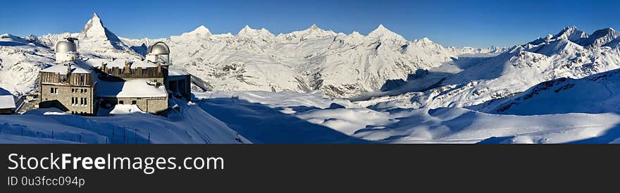 Perfect Panoramic view of the Matterhorn gornergrat mattertal weisshorn in Zermatt at a perfect sunny day, with blue sky and perfect light. The snowy Swiss mountains and landscape in winter is extraordinary. After a long skiing day these views are incredible. Perfect Panoramic view of the Matterhorn gornergrat mattertal weisshorn in Zermatt at a perfect sunny day, with blue sky and perfect light. The snowy Swiss mountains and landscape in winter is extraordinary. After a long skiing day these views are incredible