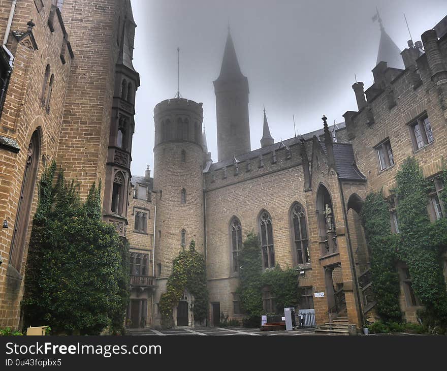 Mystic castle in the fog which looks like Hogwarts