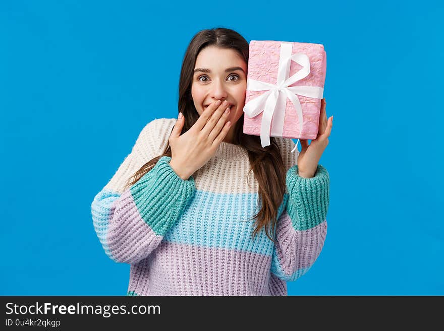 Happy cheerful cute girl guessing whats inside box, received present smiling amazed and cheerful, cant believe boyfriend bought what she wanted for christmas holidays, receive awesome gift.