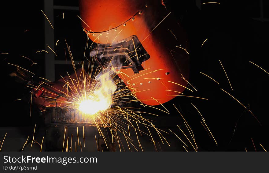 Worker with protective mask welding metal