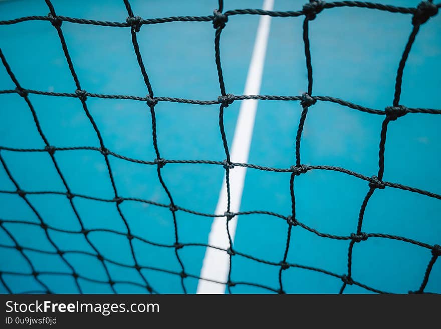 Vintage blue court tennis net. Sports Concept. Horizontal and colorful image.