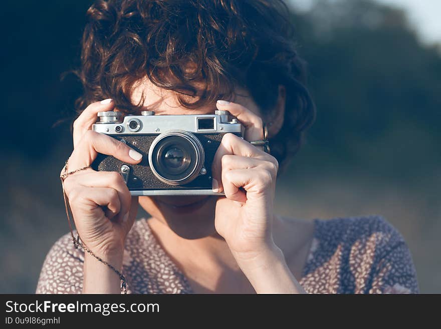 Portrait of a beautiful smiling girl with retro camera. Happy lifestyle. Portrait of a beautiful smiling girl with retro camera. Happy lifestyle