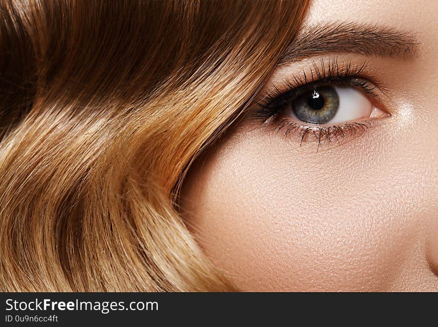 Beautiful Macro of Female Eye with Classic Makeup. Good Vision. Perfect Curly Long Lashes, Wavy Shiny Hair. Retro Beauty