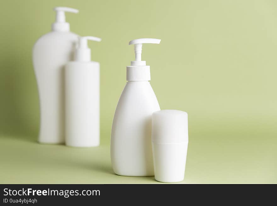 White plastic soap dispensers and deodorant. Copy space. Place for text.