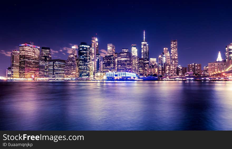 Lower Manhattan skyscrapers from New York City Harbor at night