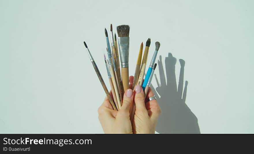 Paint Brushes In The Hand Of Painter.