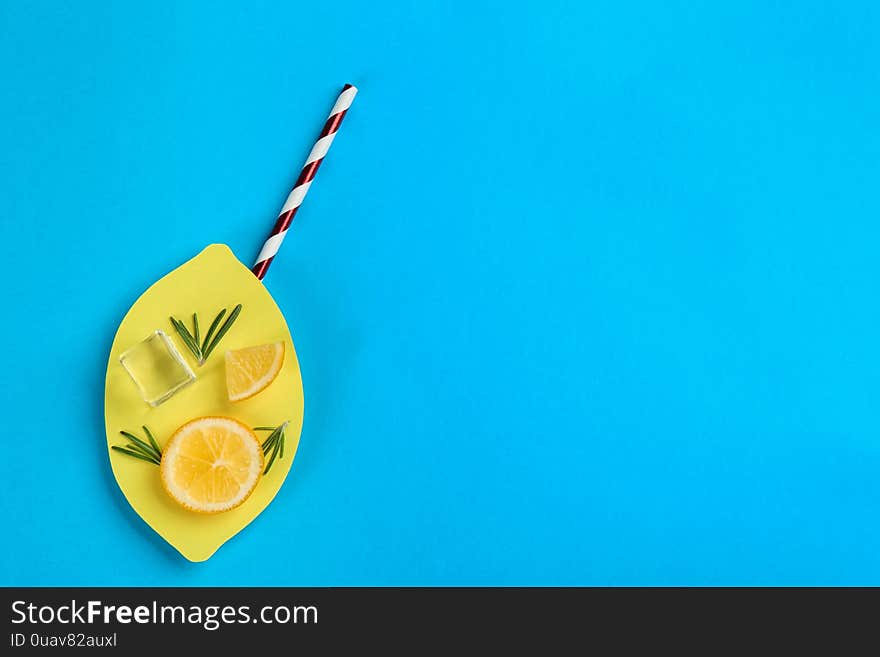 Creative lemonade layout with lemon slices on blue background, top view. Space for text