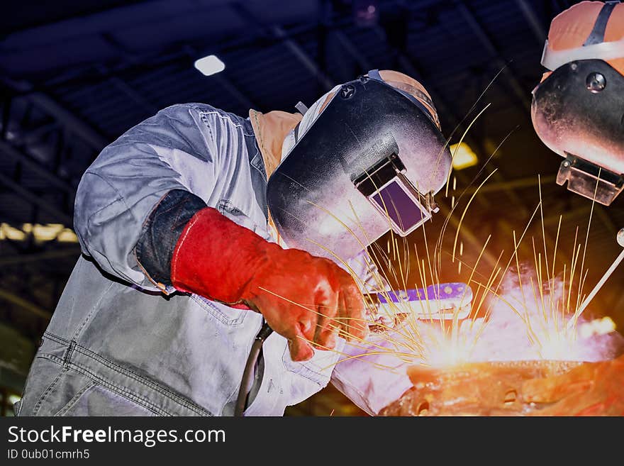 Industrial business concept with technician focus on welding process in workshop for fabrication construction site. Industrial business concept with technician focus on welding process in workshop for fabrication construction site.