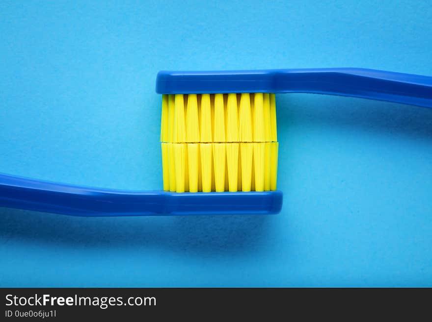 Toothbrushes displaying the stained teeth on blue background. Concept of  brushing teeth for dental hygiene or teeth stain