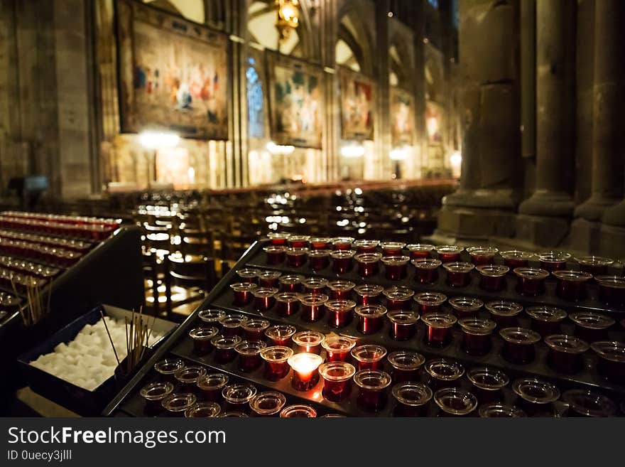 Lighting candles in a catholic temple . Candles are lit near the altar in a Catholic temple