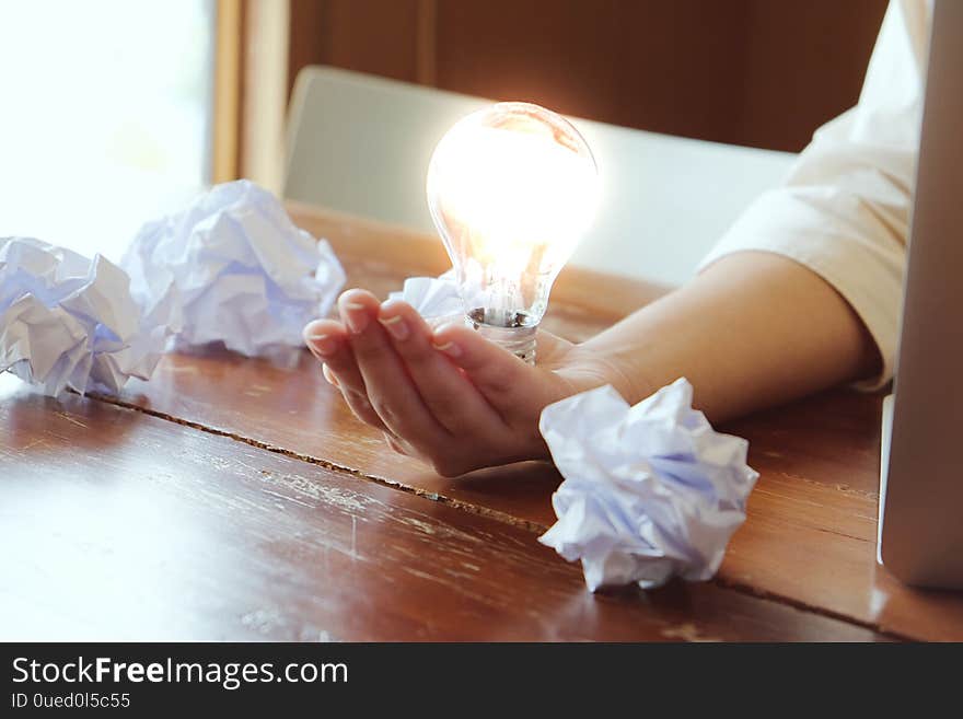 Idea of business person holding light bulb concept creativity with bulbs.