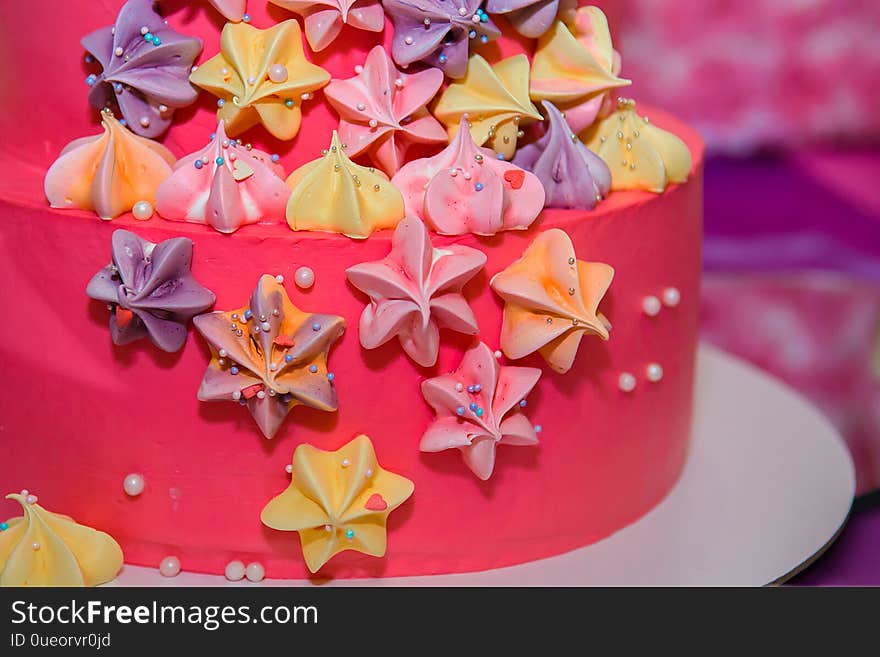 Pink cheerful cake with cream stars