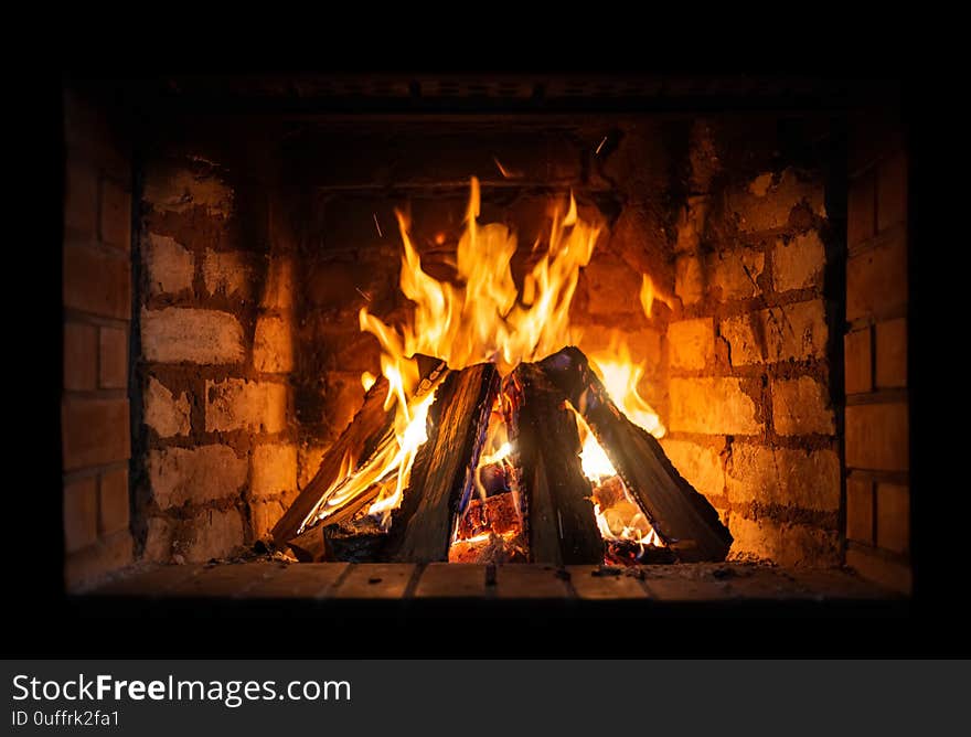 Firewood burning in a fireplace close-up