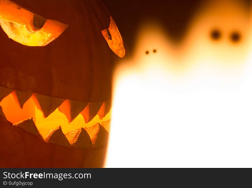 Spooky carved halloween pumpkin and creepy mystery fire ghosts