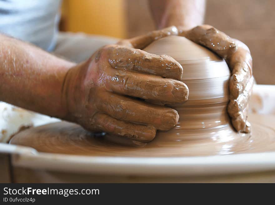 Working process of loam item in workshop. Man working in home studio. Craftsman at work. Working process of loam item in workshop. Man working in home studio. Craftsman at work