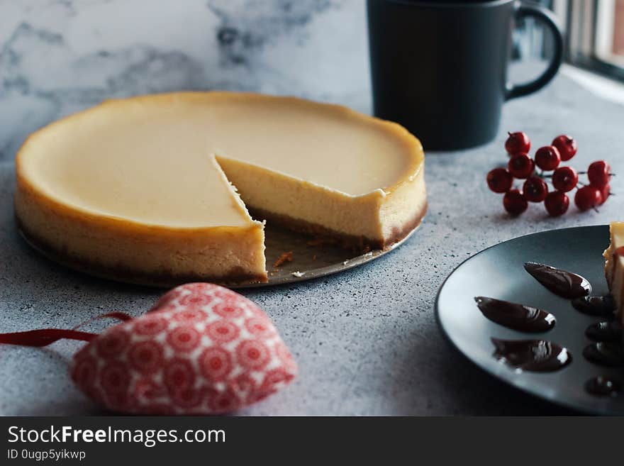 Cheesecake on a plate with strawberry sauce.