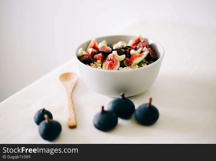 Healthy Breakfast oatmeal with figs and cashews on a white table. vegan food Healthy eating