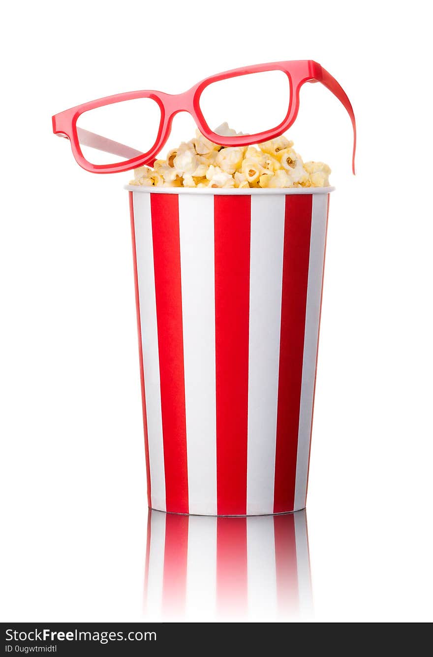 Paper striped bucket with popcorn and 3D glasses isolated on white background with clipping path. Concept of cinema or watching TV.