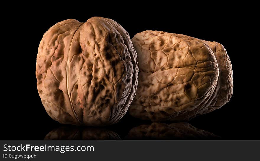 Set of whole walnuts isolated on a black background.