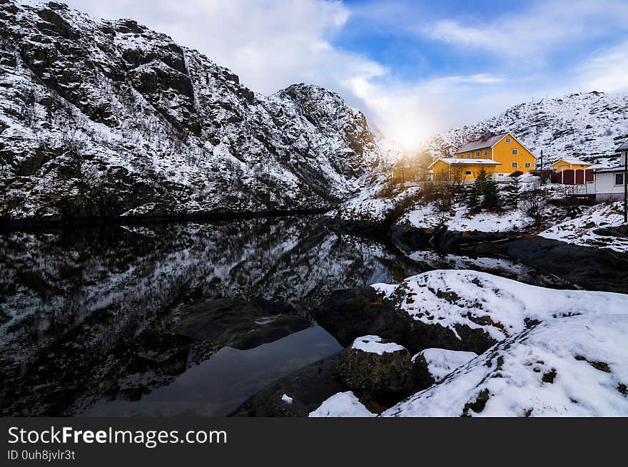 Yellow fisherman houses iconic Reine Village, Lofoten Islands, Norway