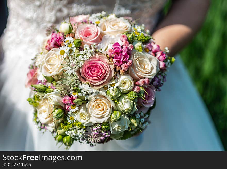 Wedding Bouquet Of Flowers Held By Bride Closeup. Pink And Yellow Roses Flowers