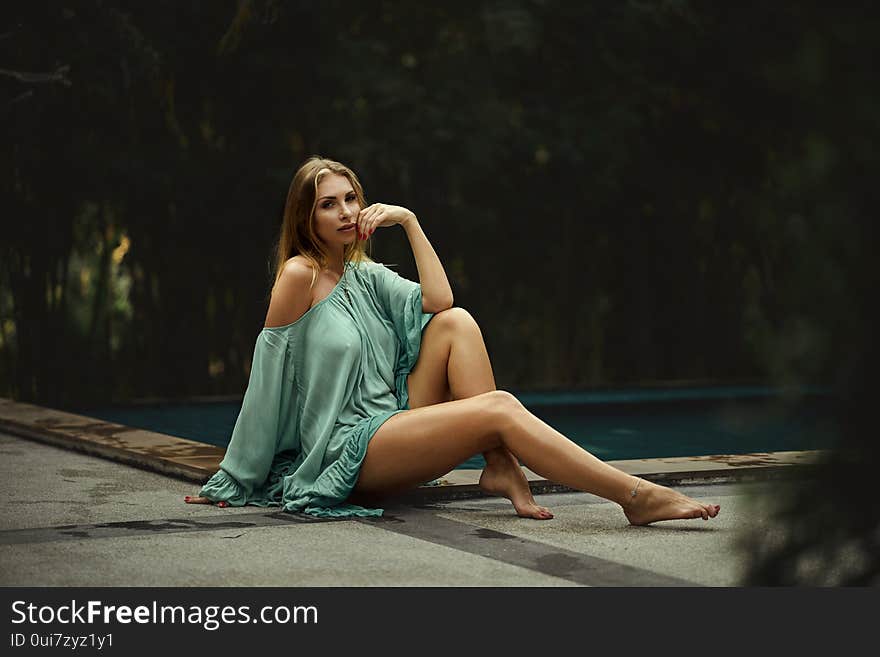 Fashion photo of beautiful young woman wearing green dress