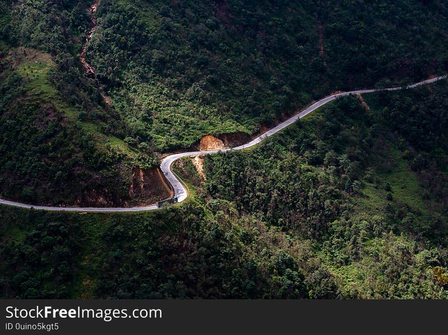 Top View Ofcountryside Road Passing Through The Green Forrest And Mountain