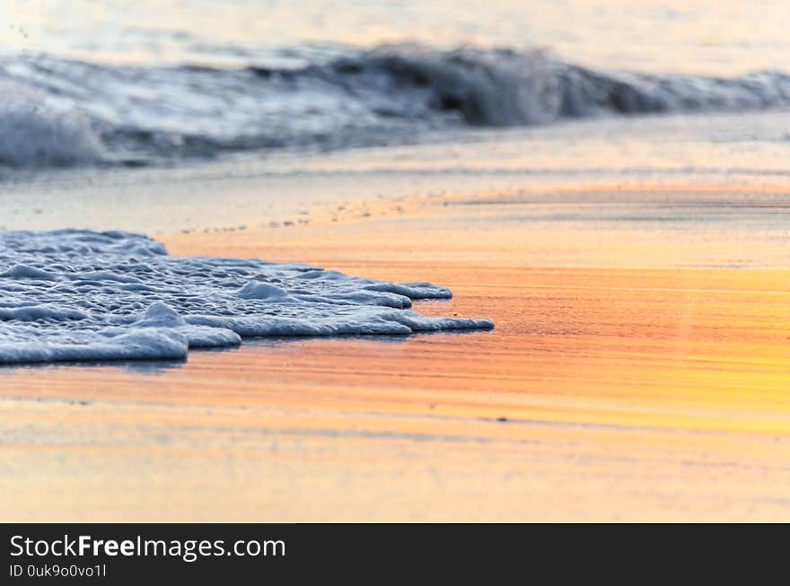 Nice sunset on the beach of Our Lady of Rocha in Lagoa, Algarve region, Portugal. Intense reflection in the sand of the sun. Nice sunset on the beach of Our Lady of Rocha in Lagoa, Algarve region, Portugal. Intense reflection in the sand of the sun