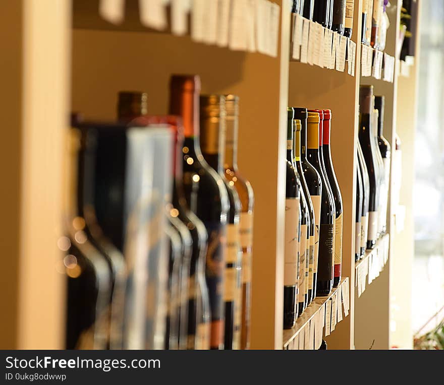 Wine Bottles On Wooden Shelf