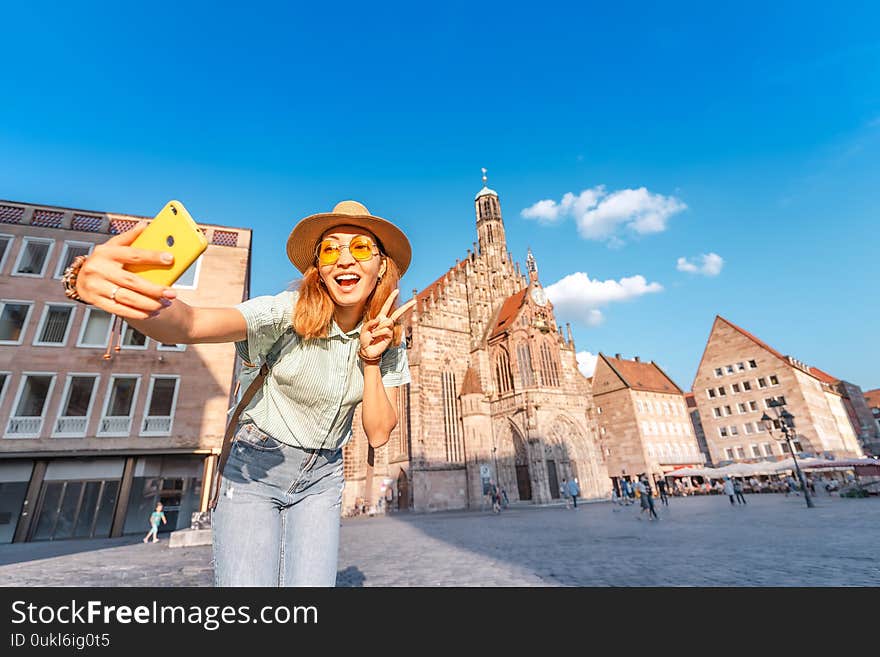 Asian girl tourist and traveller enjoying a warm summer day on the main square of Nuremberg during sunset. Sights Of Germany