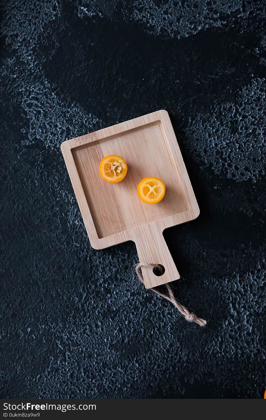 Kumquat On A Black Background On A Wooden Board, Wood