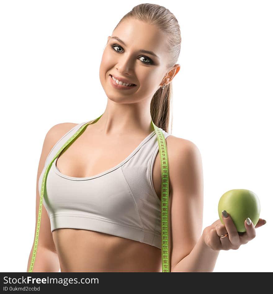 Beautiful fitness trainer with a laptop and an apple cropped isolated view on white background. Beautiful fitness trainer with a laptop and an apple cropped isolated view on white background