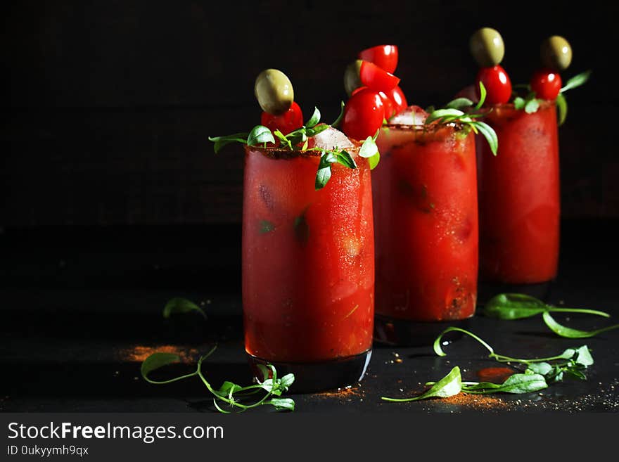 Three glasses with Bloody Mary cocktail