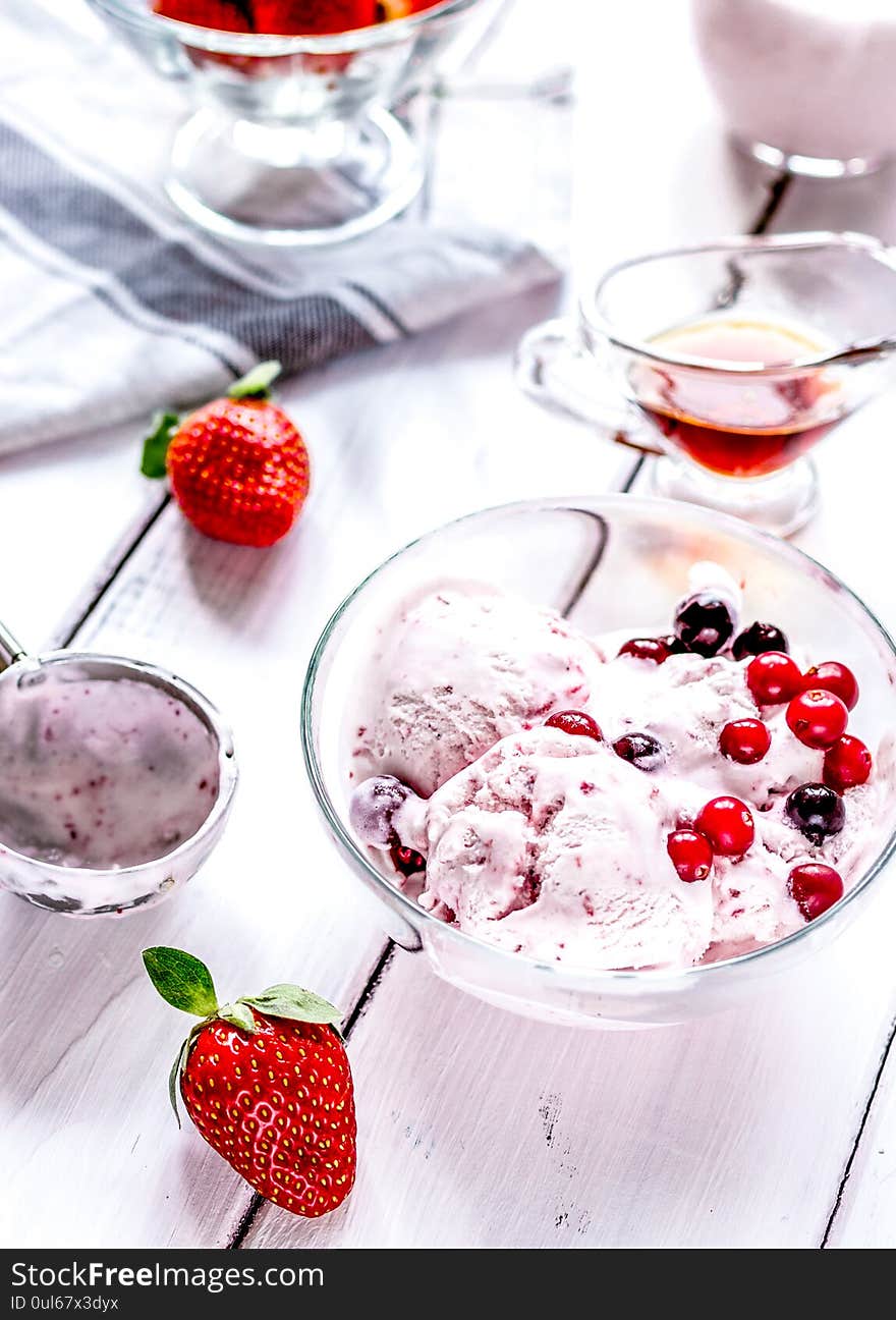 Organic homemade ice cream with strawberry in glass bowl on wooden background. Organic homemade ice cream with strawberry in glass bowl on wooden background