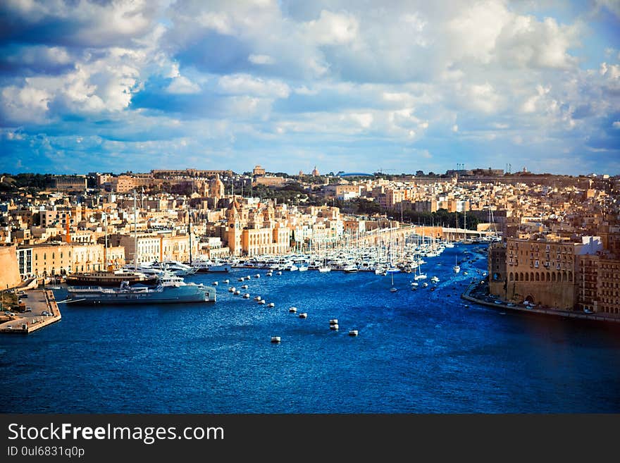 Boats in harbor of Valletta, capital of Malta. Scenic view of maltese coast with ships and traditional houses. Popular famous