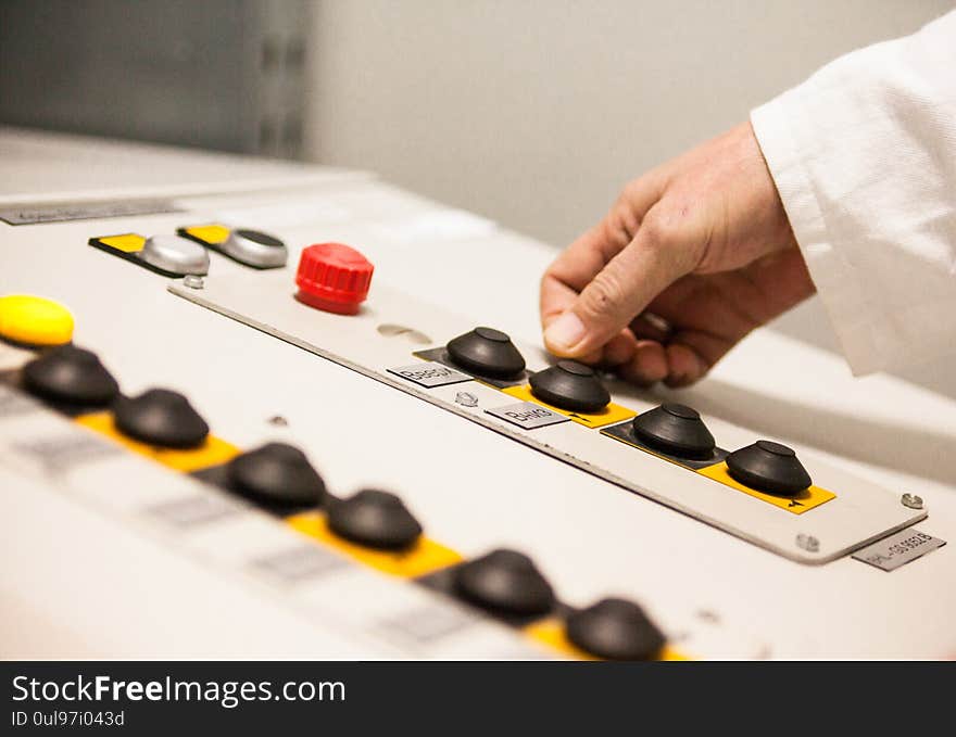 Male hand pushing the button on the control panel of the industrial plant. Close up