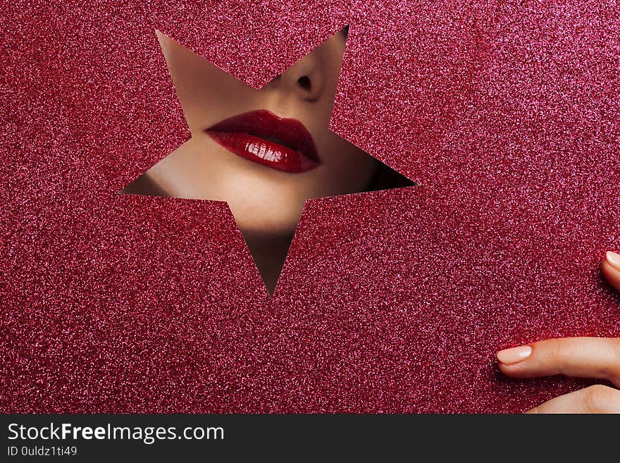 Sexy female lips in a star-shaped cutout.