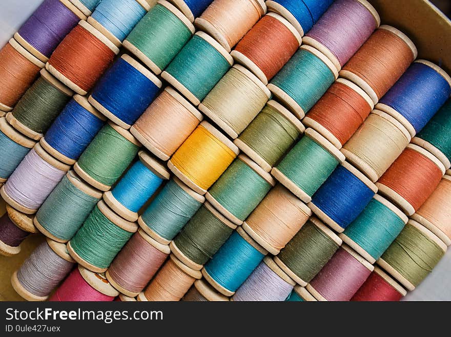 Rolls of colorful threads, close-up and top view. home set for clothes repair, colorful thread