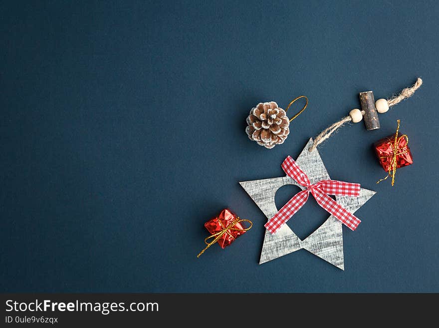 Christmas and New Year background with gifts, deer, stars and fir-trees, flat lay on a dark blue background, holiday greetings, concept of a winter background with free space