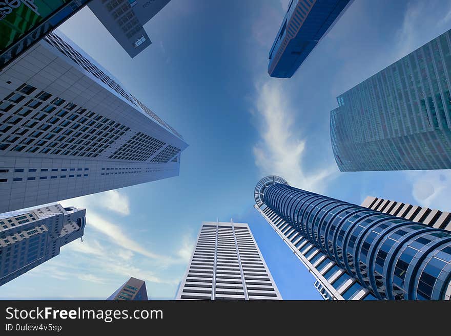 Low angle view of singapore financial buildings at bright sunny day.