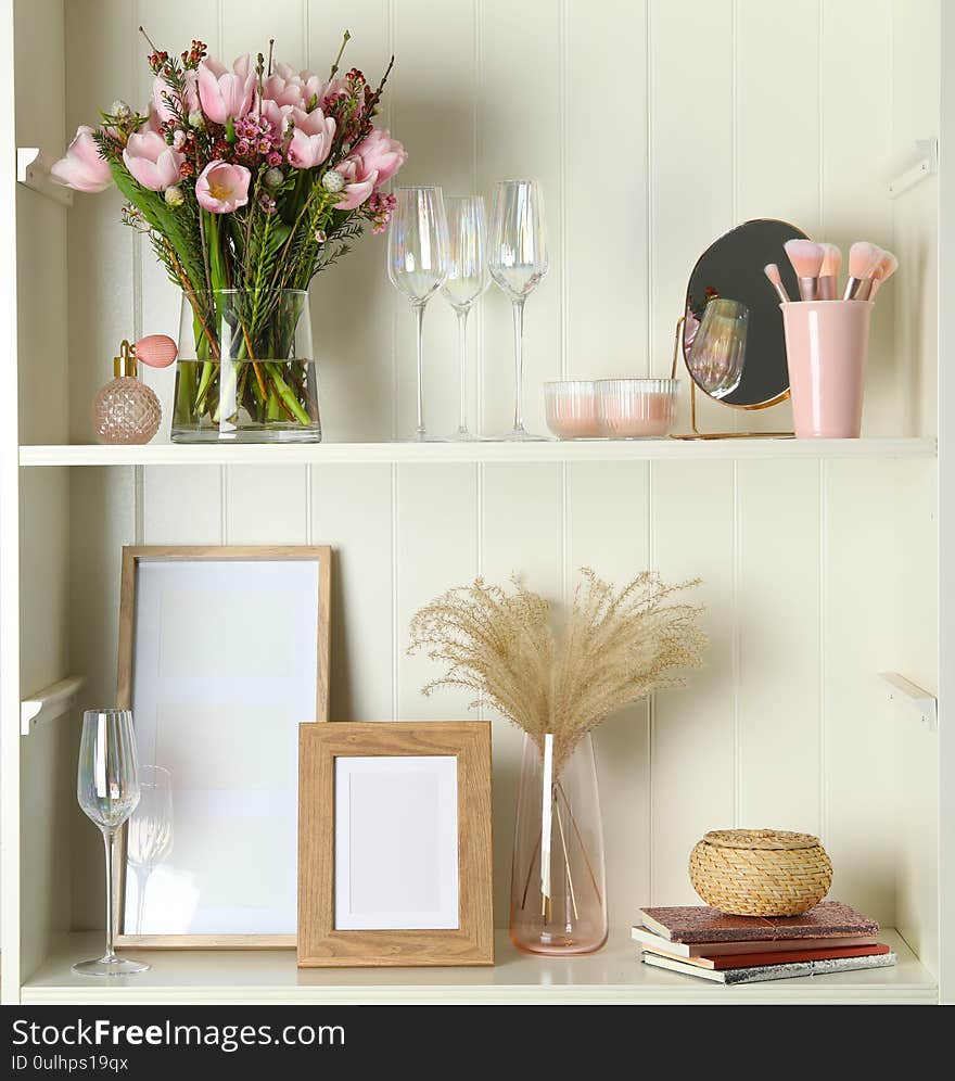 White shelving unit with glassware and decorative elements