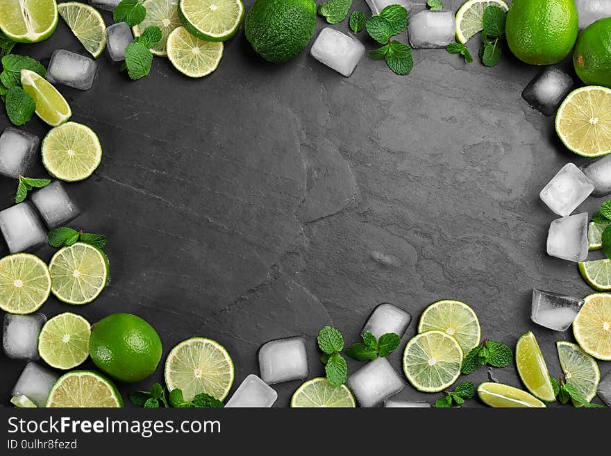 Frame made of lime slices, mint and ice on table, top view with space for text. Lemonade layout