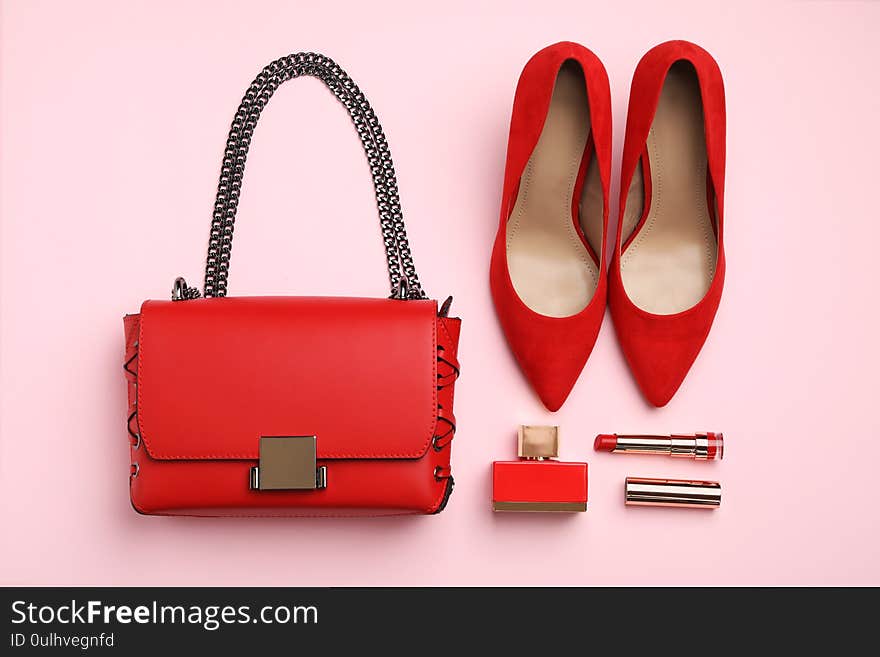 Flat lay composition with stylish woman`s bag and accessories on pink background