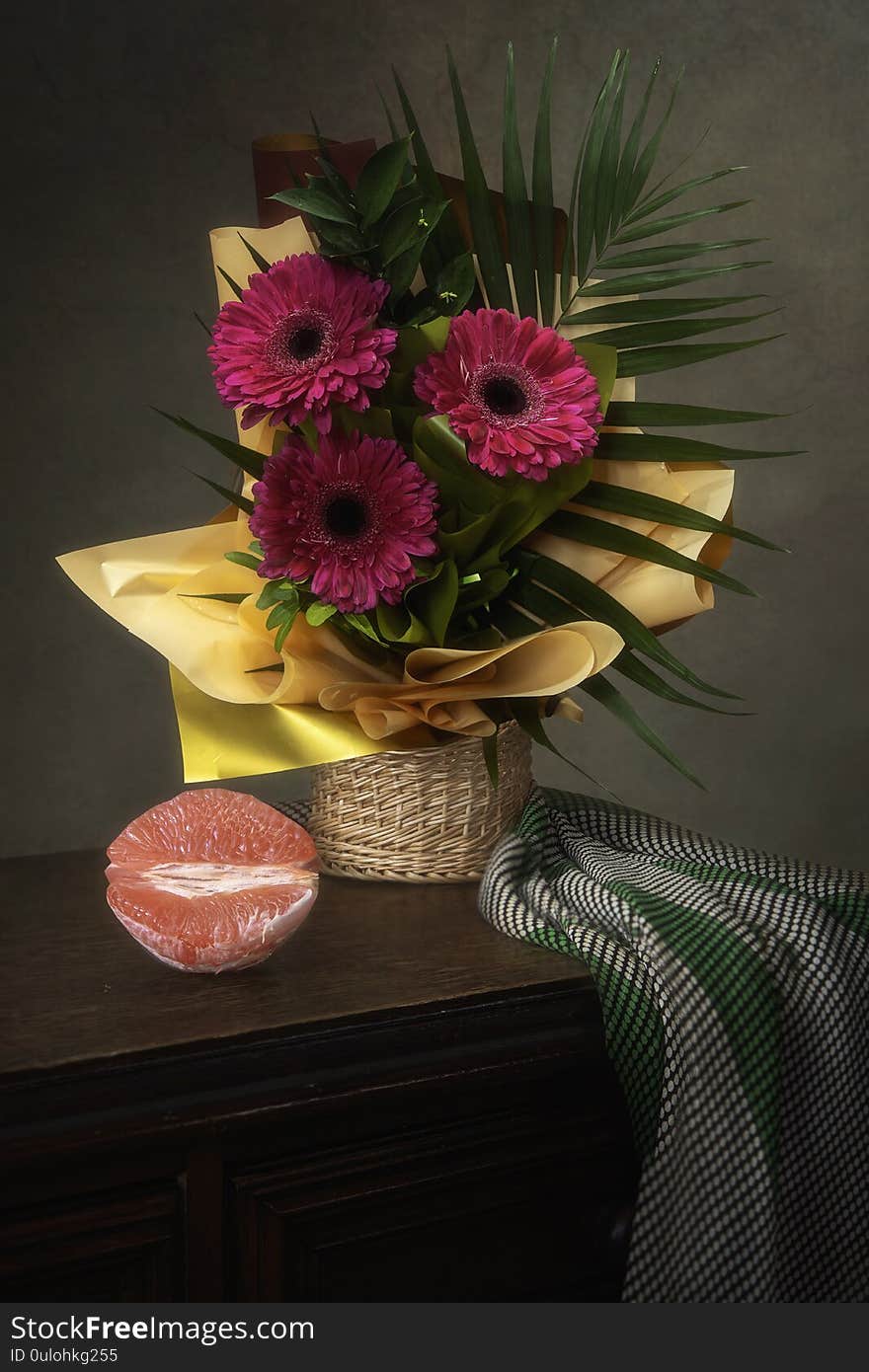 Still life with a beautiful bouquet of gerberas in a gift wrapper