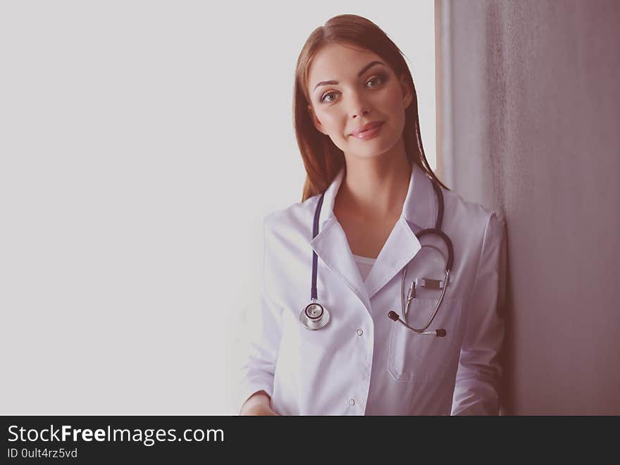 Portrait of female doctor standing against isolated on white background. Woman doctor.