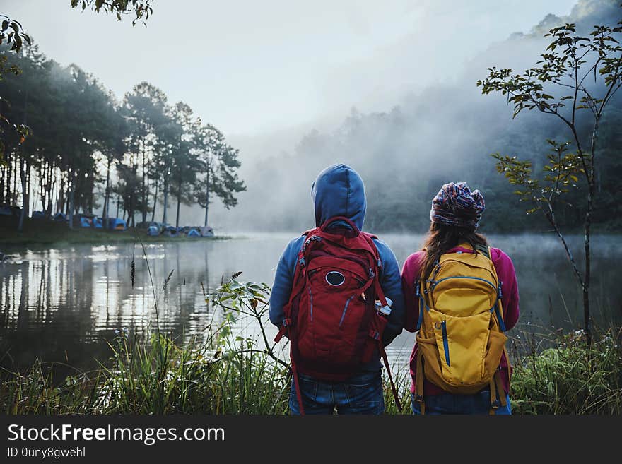 Couples who love to travel, take pictures Beatiful nature at Pang ung lake and pine forest at Mae Hong Son in Thailand.