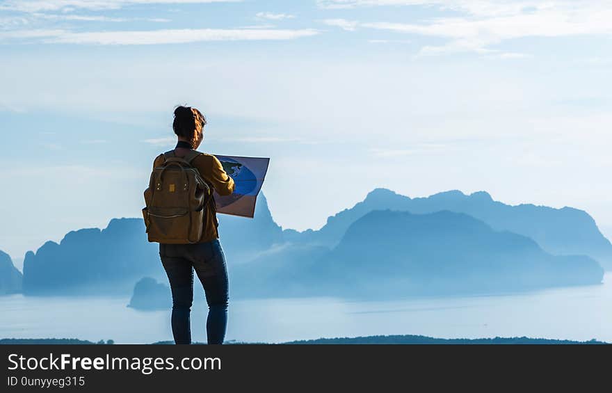 Travelers, young woman are exploring the map. Landscape Beautiful Mountain on sea at Samet Nangshe Viewpoint. Phang Nga Bay ,Travel adventure, Travel Thailand, Tourist on summer holiday vacation. Travelers, young woman are exploring the map. Landscape Beautiful Mountain on sea at Samet Nangshe Viewpoint. Phang Nga Bay ,Travel adventure, Travel Thailand, Tourist on summer holiday vacation.