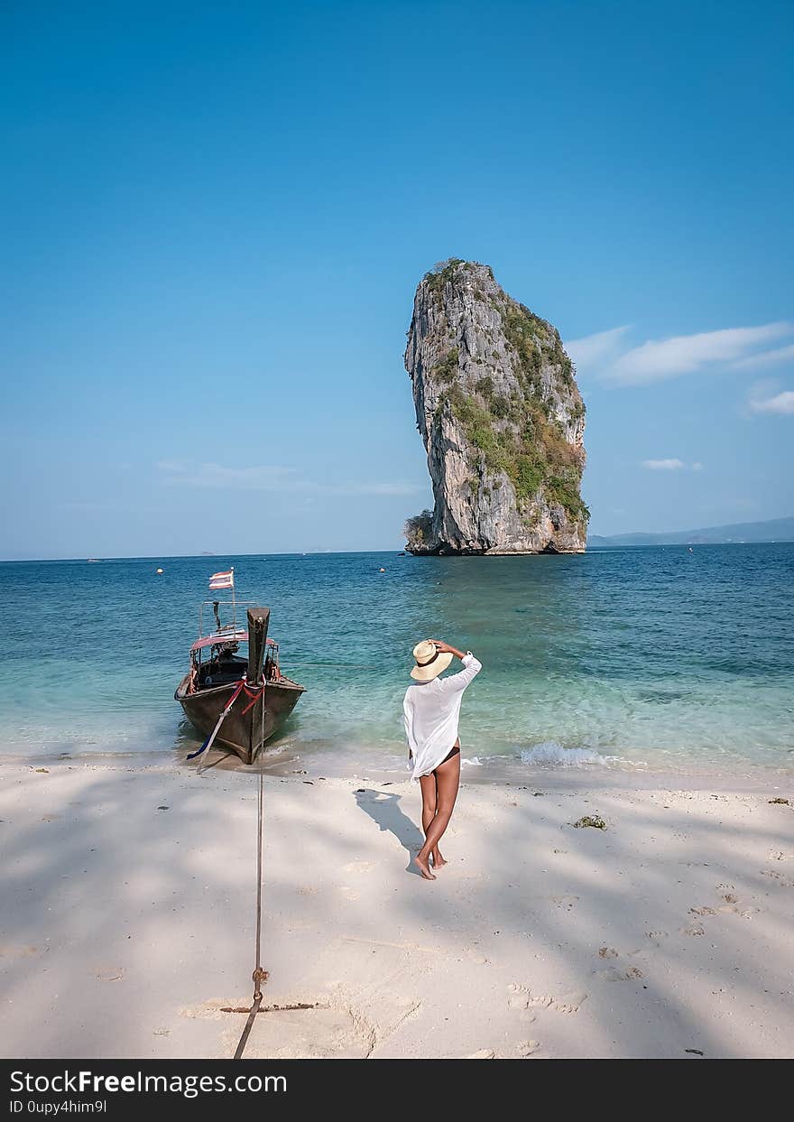 Koh Poda Krabi Thailand, white beach with crystal clear water in Krabi Thailand Asia, woman with hat on the beach Asia