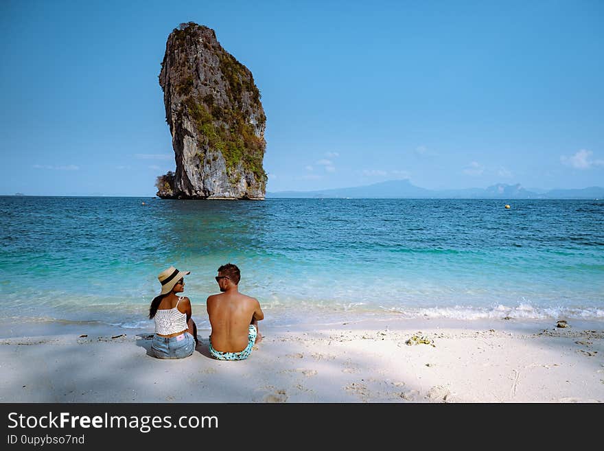 Couple men and woman on the ebach, Koh Poda Krabi Thailand, white beach with crystal clear water in Krabi Thailand